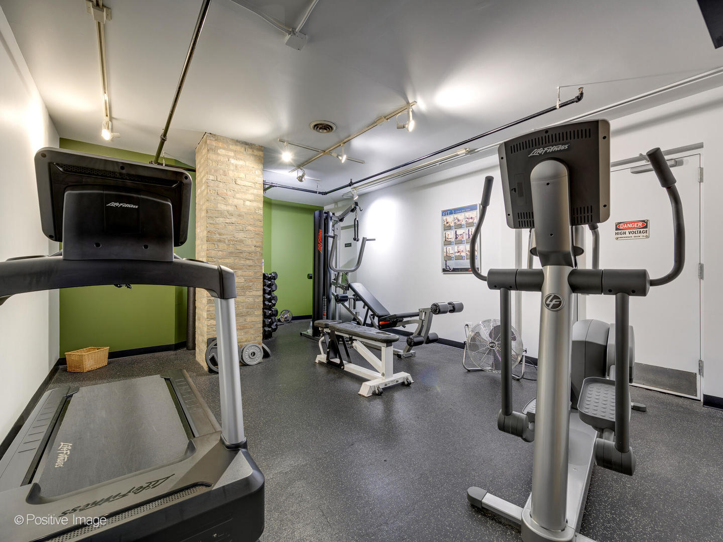 203 South Sangamon Street, Unit 213 Chicago, IL 60607 - Photo 20 of 23 a room with gym equipment and a mirror