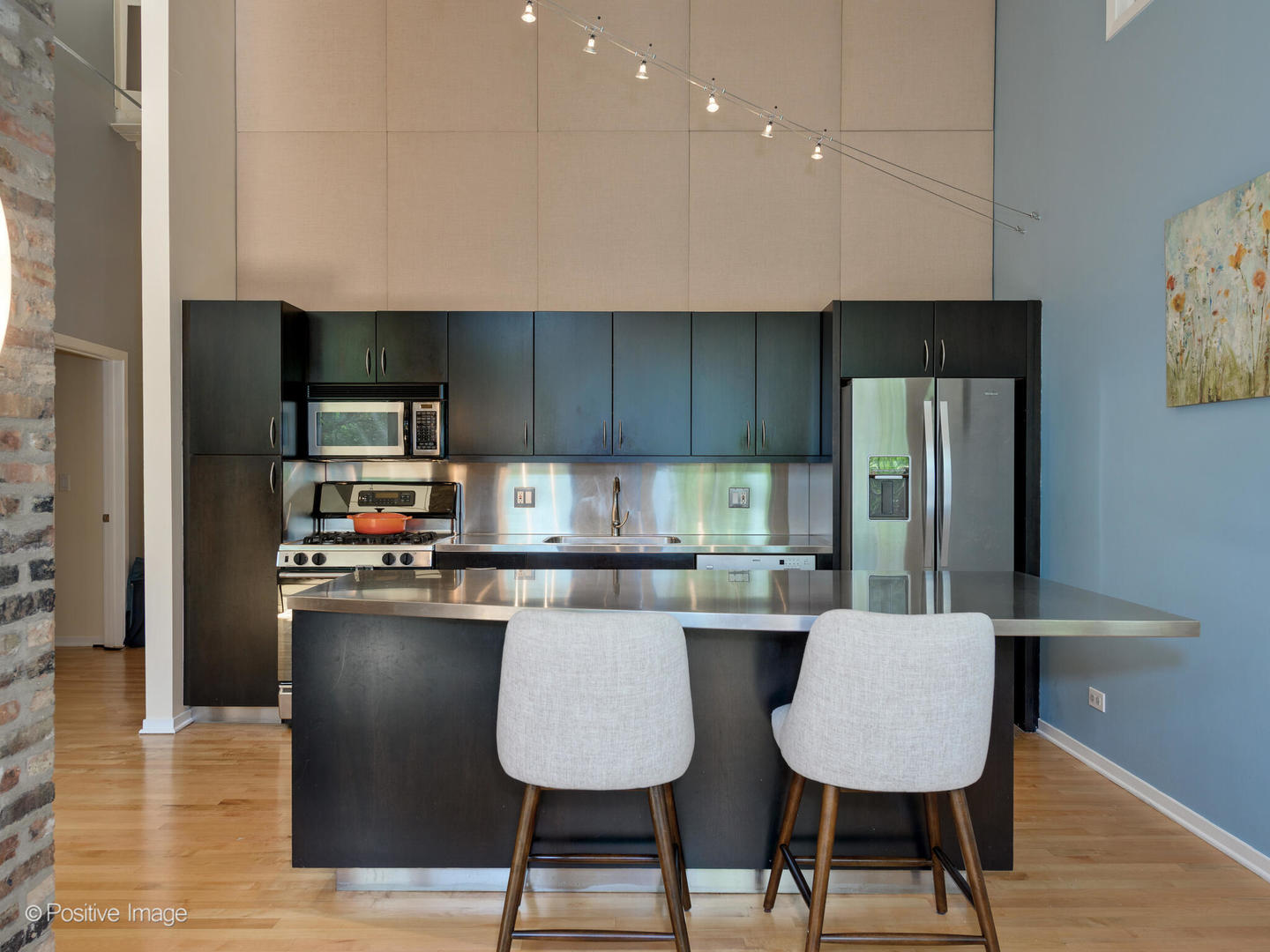 203 South Sangamon Street, Unit 213 Chicago, IL 60607 - Photo 9 of 23 a kitchen with stainless steel appliances kitchen island granite countertop a refrigerator a stove top oven a sink and dishwasher