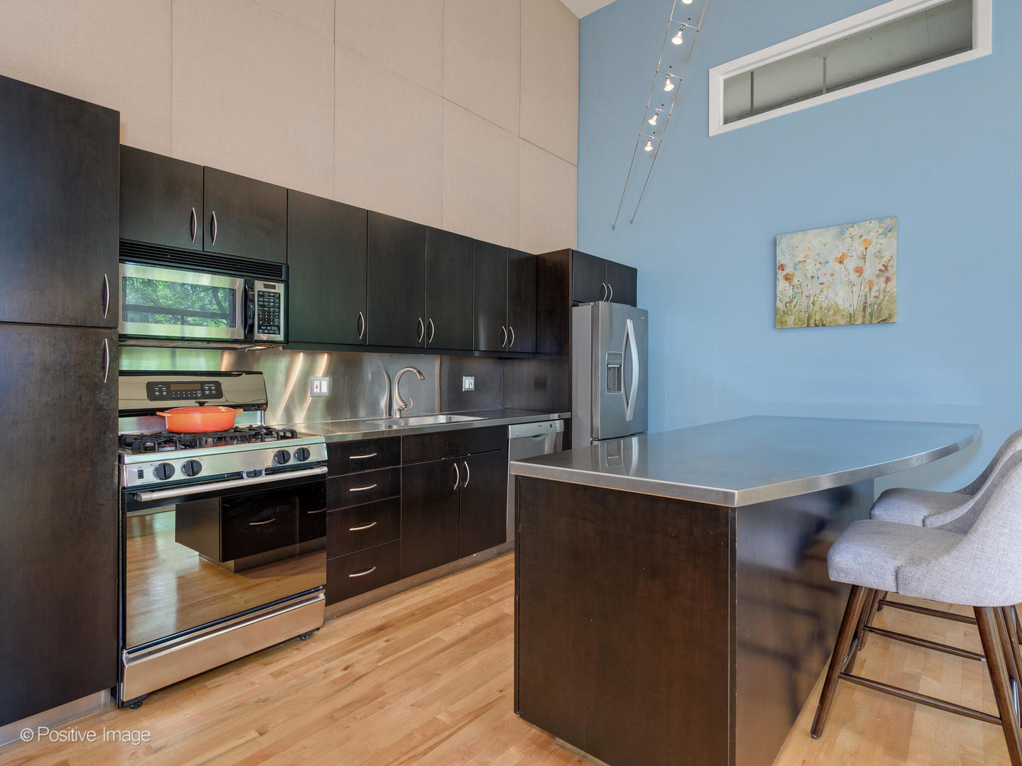 203 South Sangamon Street, Unit 213 Chicago, IL 60607 - Photo 10 of 23 a kitchen with stainless steel appliances granite countertop a stove a sink and a refrigerator