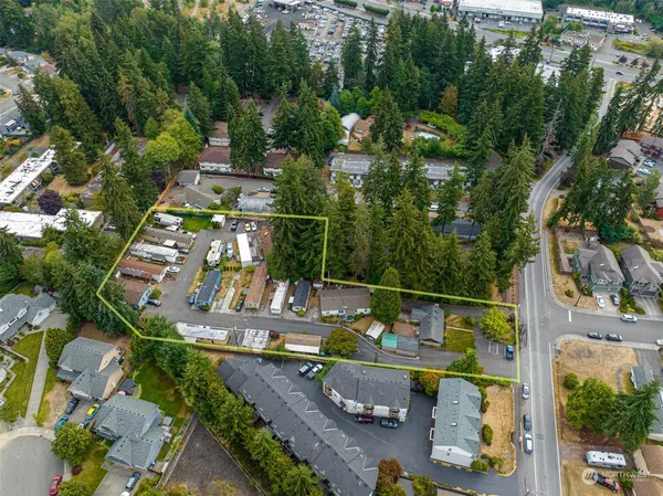 an aerial view of a swimming pool with a yard