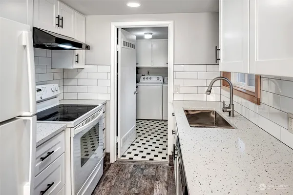a kitchen with a sink a stove and cabinets