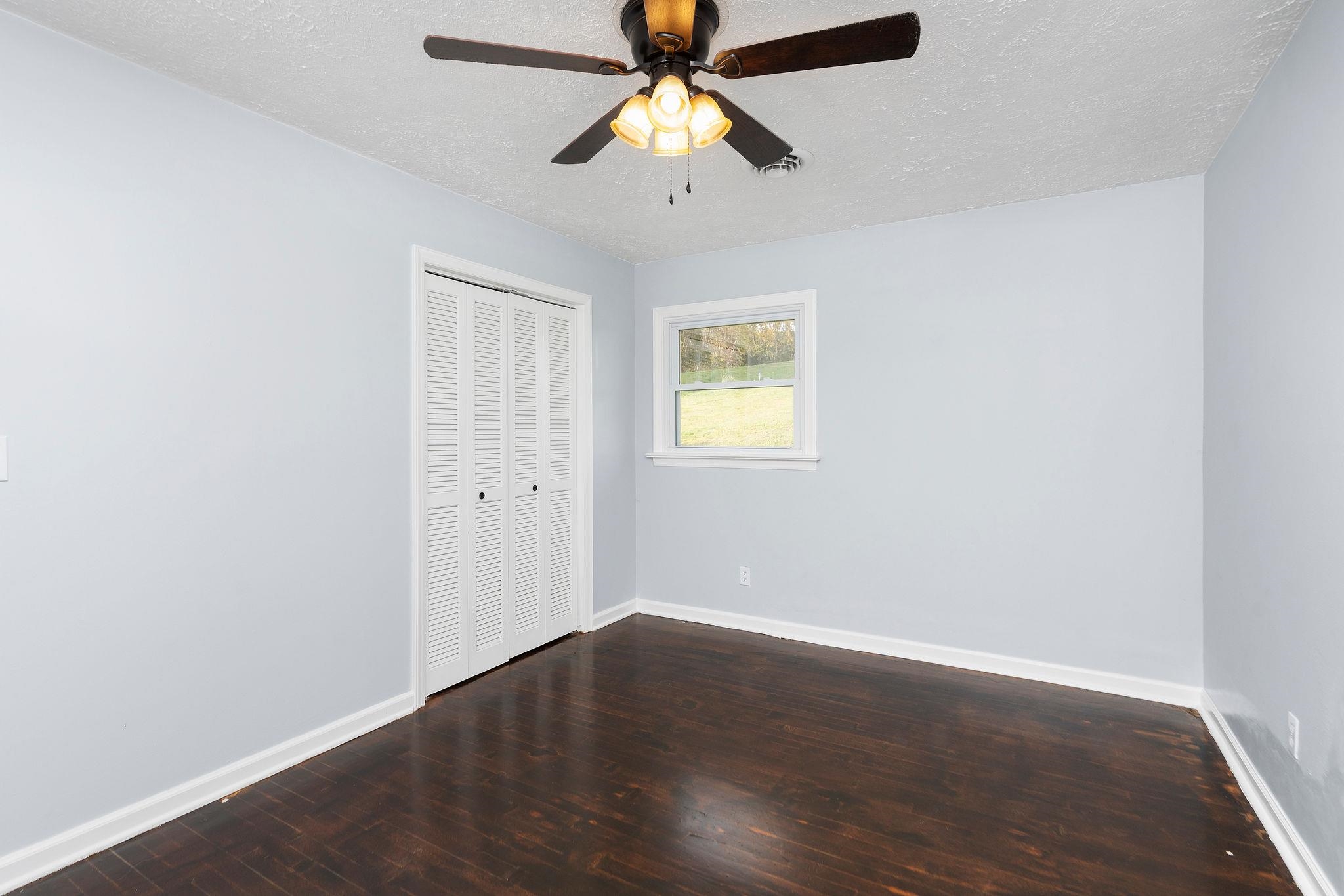 1111 Jennings Gap Road Churchville, VA 24421 - Photo 18 of 75 an empty room with a window and a chandelier fan