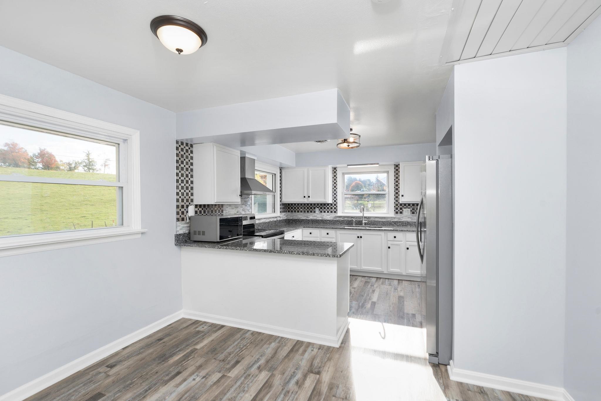 1111 Jennings Gap Road Churchville, VA 24421 - Photo 22 of 75 a kitchen with granite countertop a sink cabinets and window