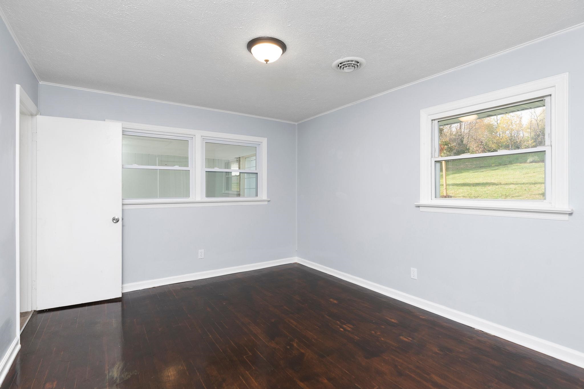1111 Jennings Gap Road Churchville, VA 24421 - Photo 35 of 75 a view of an empty room with wooden floor and a window