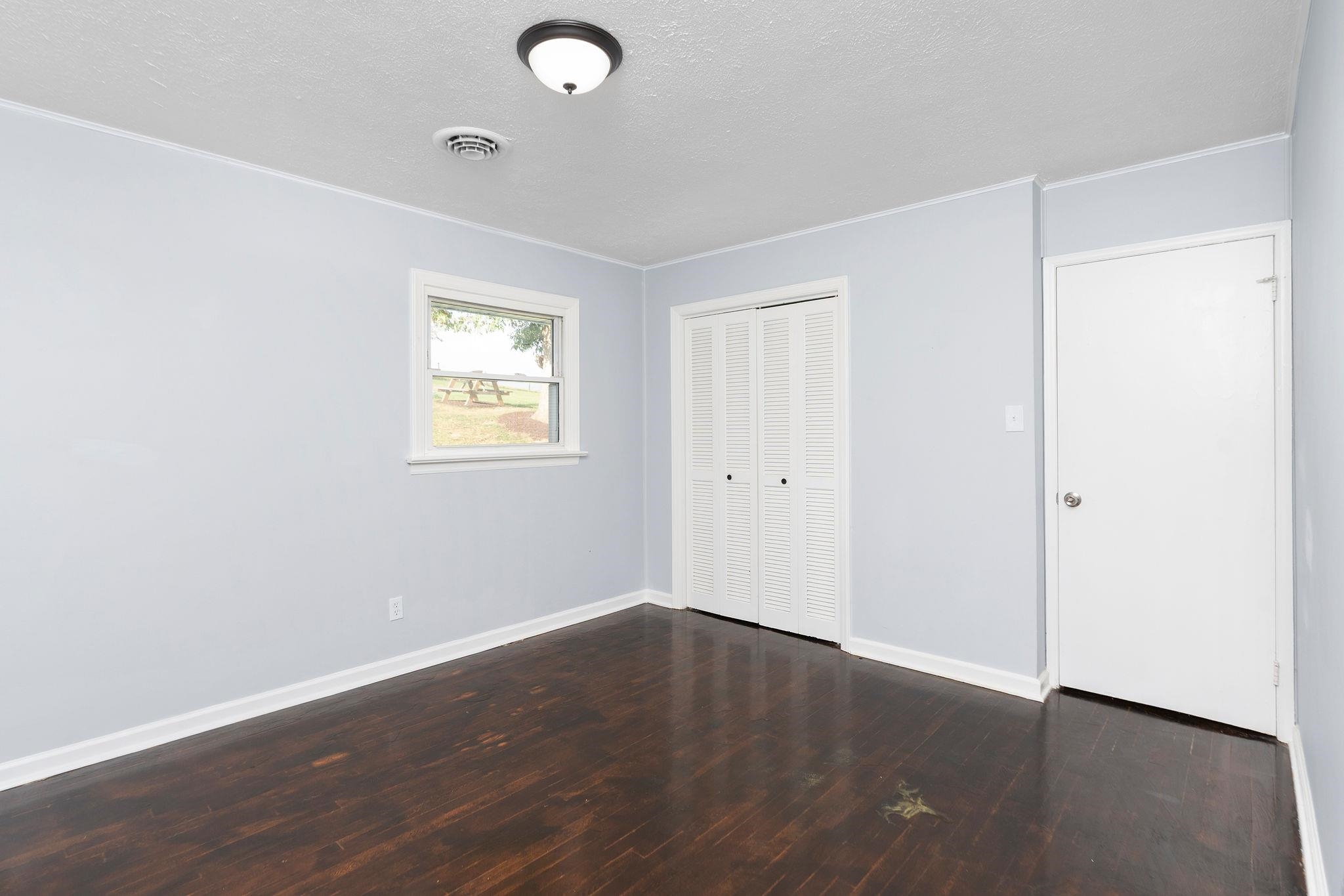 1111 Jennings Gap Road Churchville, VA 24421 - Photo 36 of 75 an empty room with wooden floor and windows