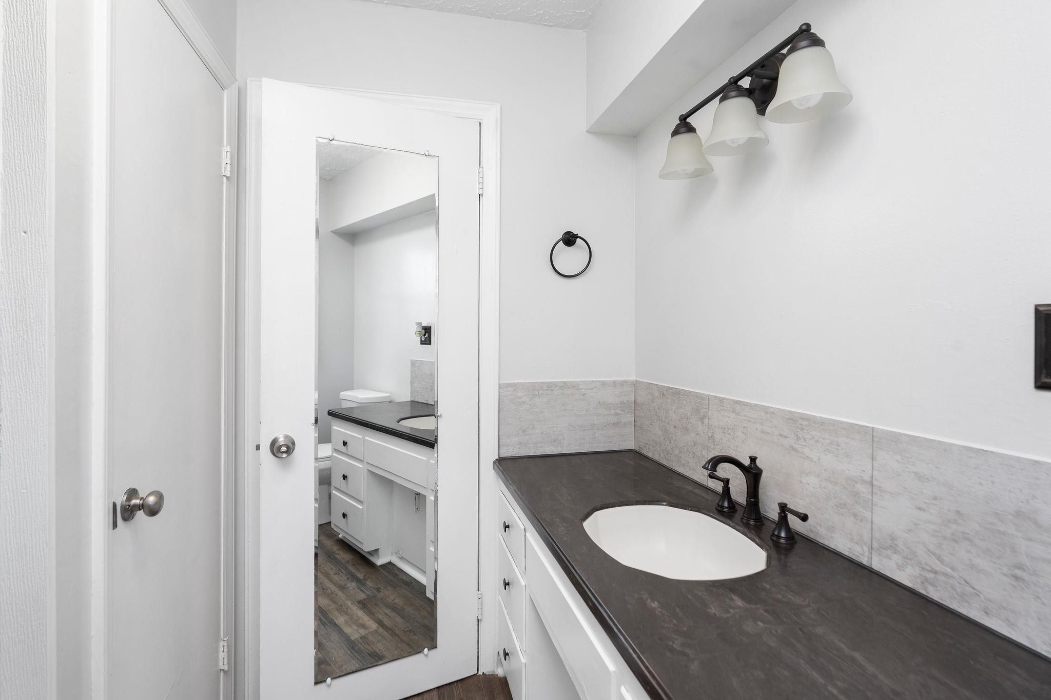 1111 Jennings Gap Road Churchville, VA 24421 - Photo 37 of 75 a bathroom with a granite countertop sink toilet and shower
