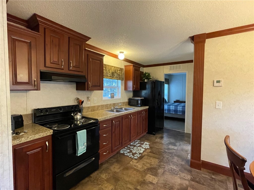 9737 Black Jack Road Macclenny, FL 32063 - Photo 6 of 14 New fridge in galley kitchen open to living and di