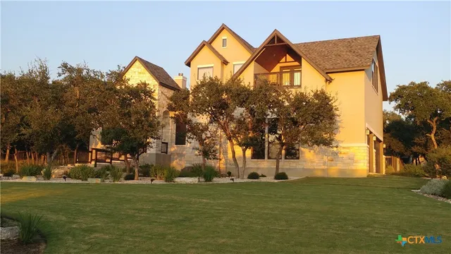 a front view of a house with a big yard