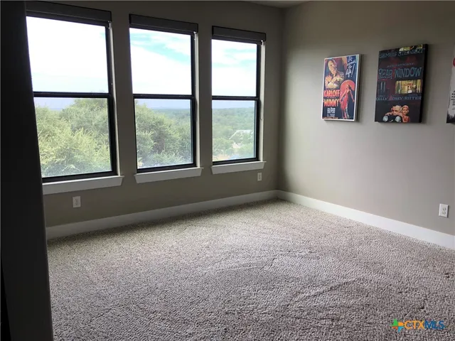 a living room with furniture ceiling fan and a window