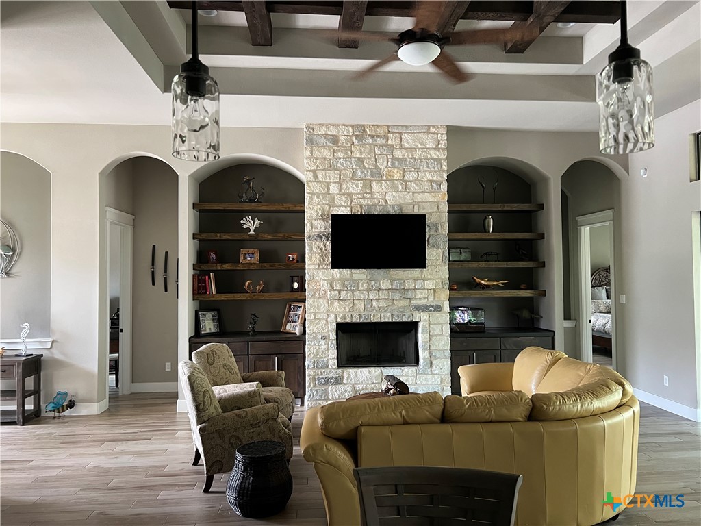 407 Havasu Point Spring Branch, TX 78070 - Photo 20 of 36 a living room with furniture a fireplace and a flat screen tv