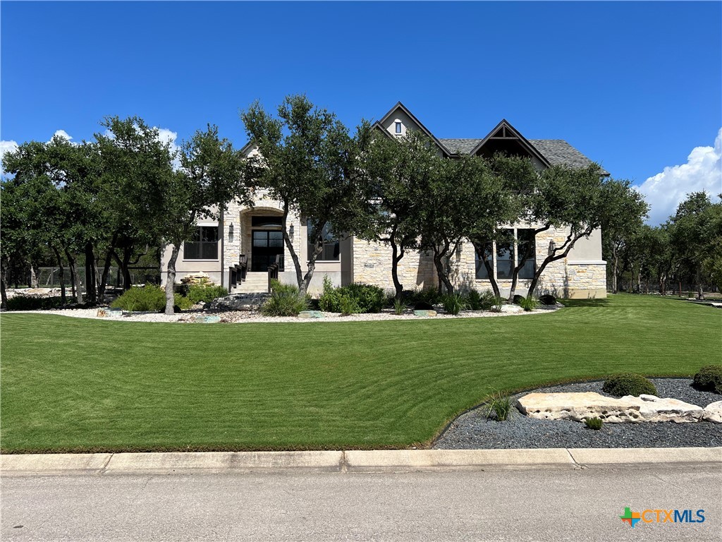 407 Havasu Point Spring Branch, TX 78070 - Photo 2 of 36 front view of a house with a garden