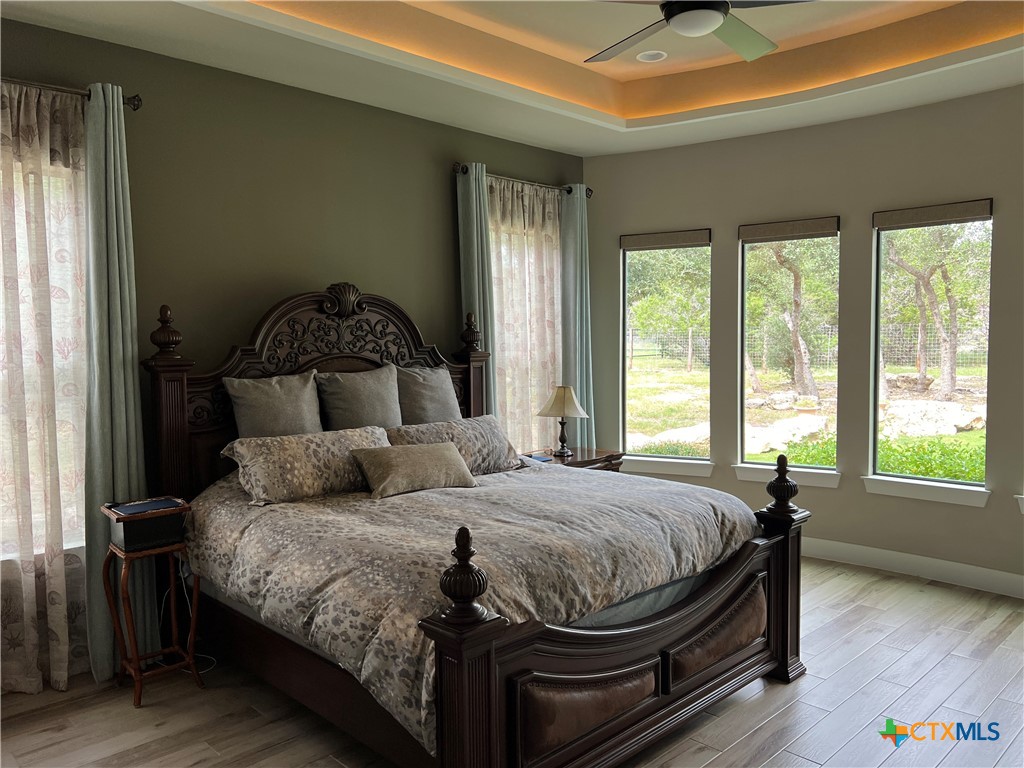 407 Havasu Point Spring Branch, TX 78070 - Photo 22 of 36 a bedroom with a bed and wooden floor