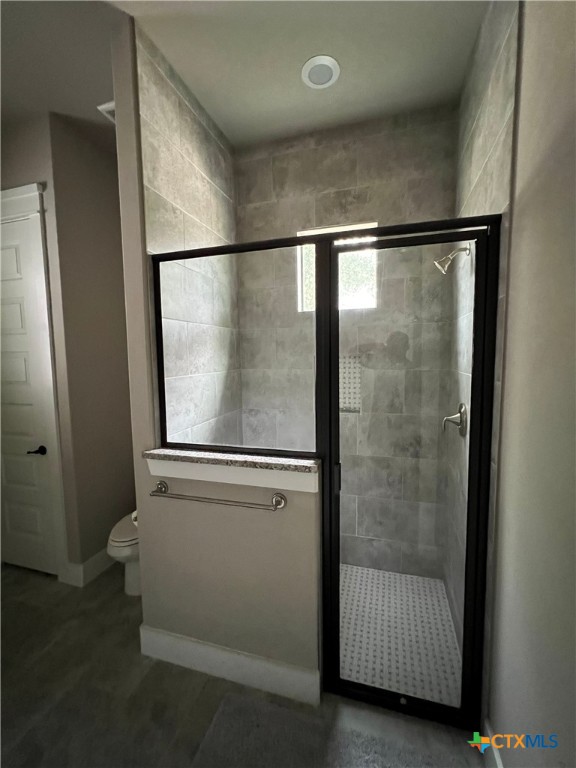 407 Havasu Point Spring Branch, TX 78070 - Photo 24 of 36 a bathroom with a glass shower door