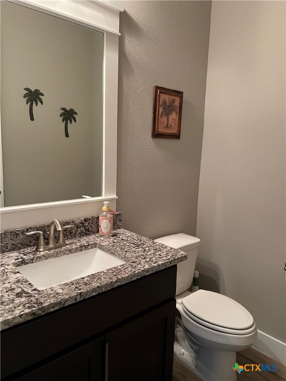 407 Havasu Point Spring Branch, TX 78070 - Photo 27 of 36 a bathroom with a granite countertop toilet sink and mirror