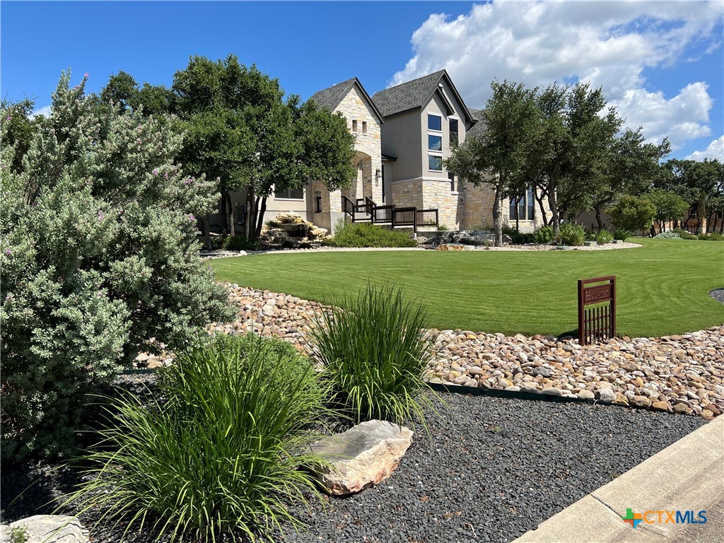407 Havasu Point Spring Branch, TX 78070 - Photo 3 of 36 a view of a white house with a yard and sitting area