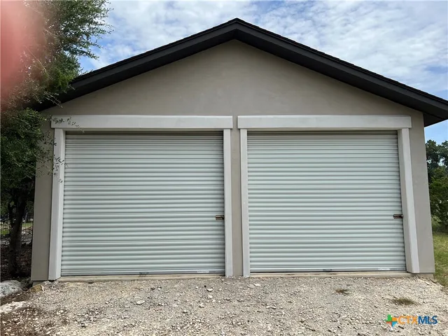 a kitchen with stainless steel appliances kitchen island granite countertop a refrigerator and a stove top oven