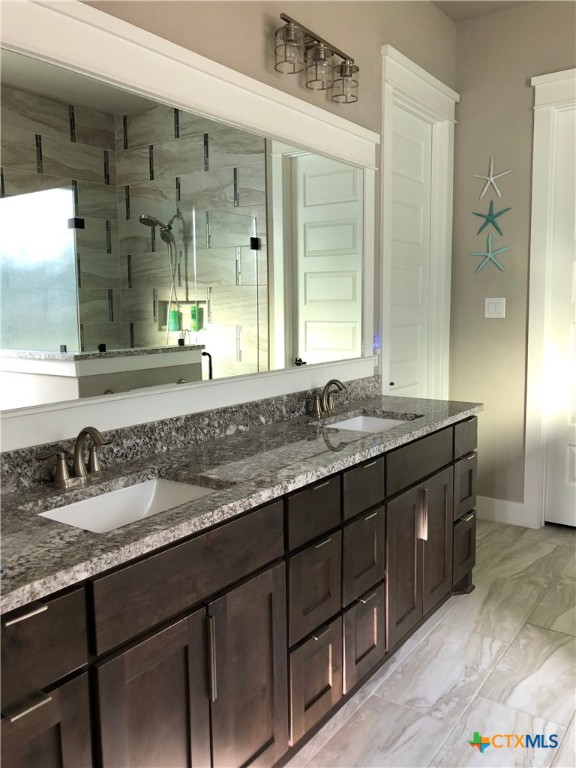 407 Havasu Point Spring Branch, TX 78070 - Photo 35 of 36 a bathroom with a granite countertop sink mirror and double