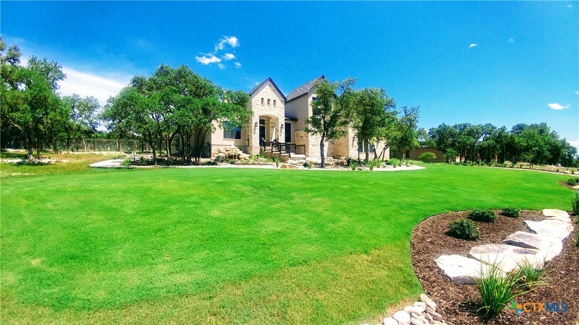 407 Havasu Point Spring Branch, TX 78070 - Photo 9 of 36 a front view of a house with a garden