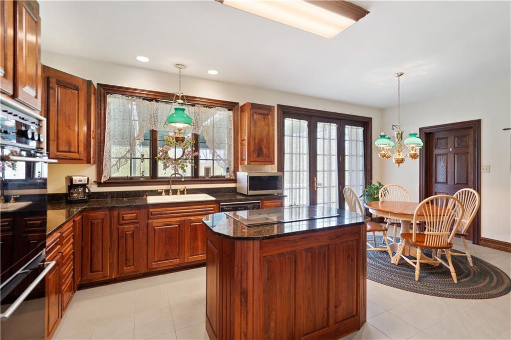 243 Clark Road Perryopolis, PA 15473 - Photo 11 of 45 a kitchen with stainless steel appliances granite countertop wooden cabinets a dining table and chairs