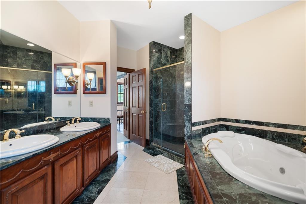 243 Clark Road Perryopolis, PA 15473 - Photo 23 of 45 a spacious bathroom with a bathtub sink and mirror