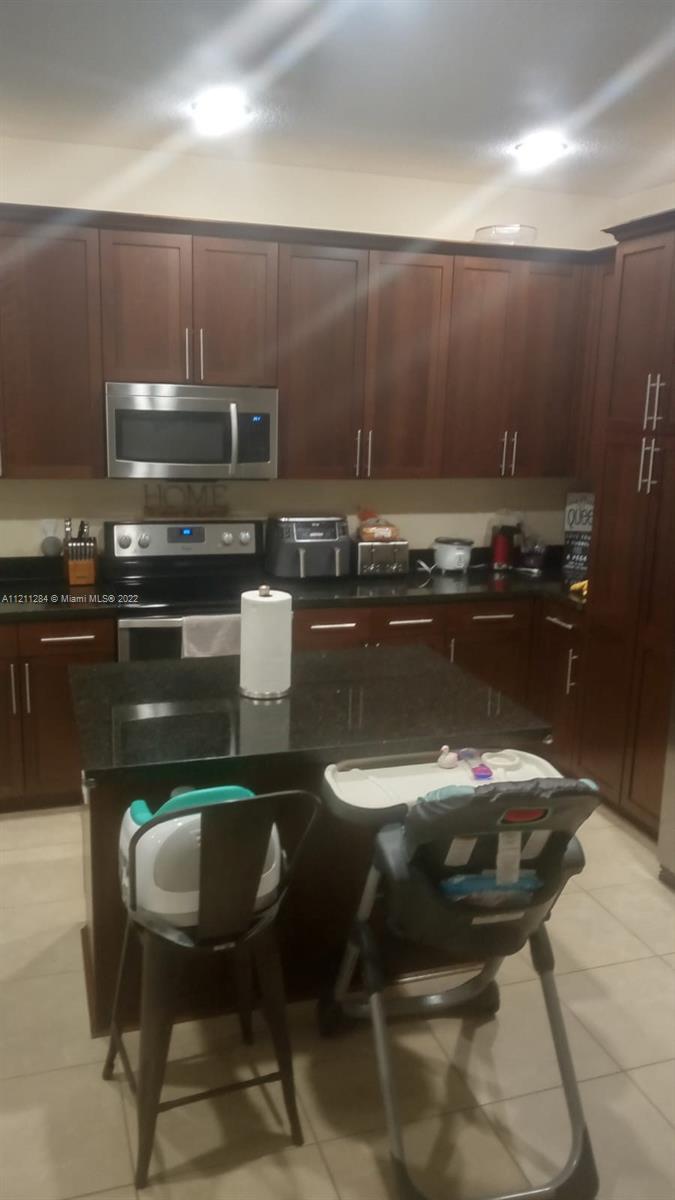 a kitchen with a table chairs and microwave
