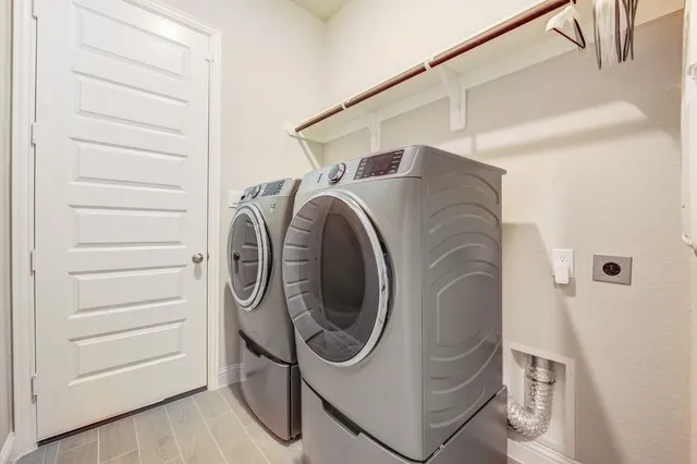 a view of an empty room with a chandelier fan