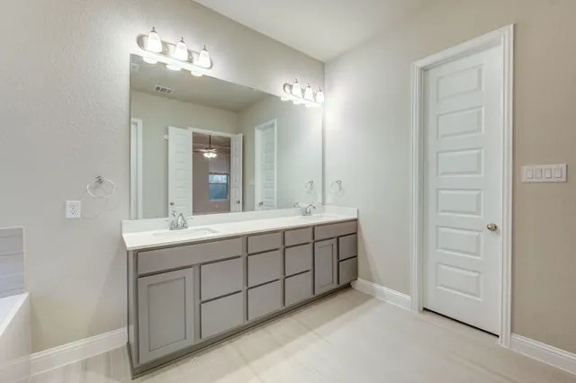 a bathroom with a bathtub and a sink