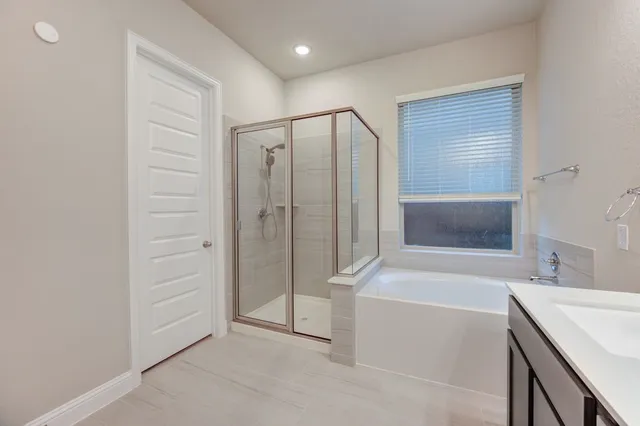a bathroom with a double vanity sink toilet mirror and bathtub