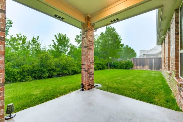 a view of a back yard from a tub