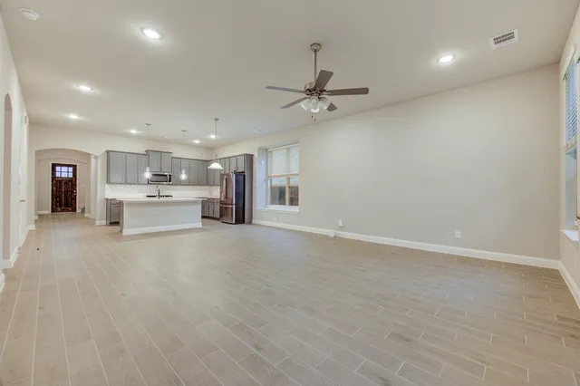 a view of kitchen with stainless steel appliances refrigerator oven and cabinets