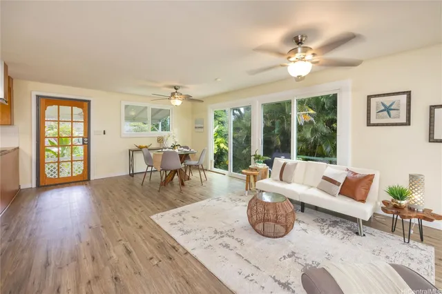 a living room with furniture and wooden floor