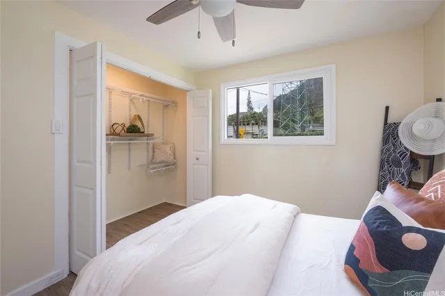 a bedroom with a bed and wooden floor