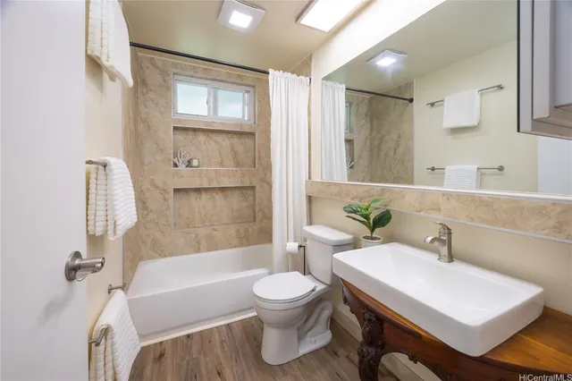 a bathroom with a sink toilet bathtub and shower