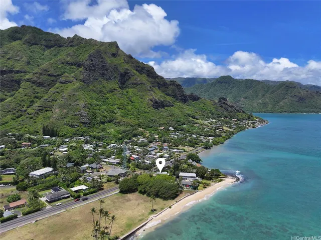 an aerial view of a residential houses with outdoor space and trees