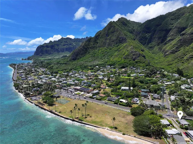 a view of a houses with a lush green forest