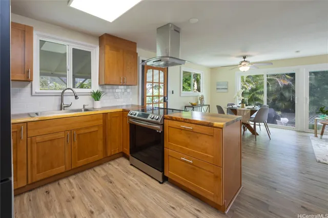 a kitchen with a sink stove and wooden cabinets