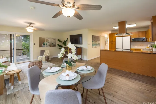 a dining room with furniture a window and wooden floor