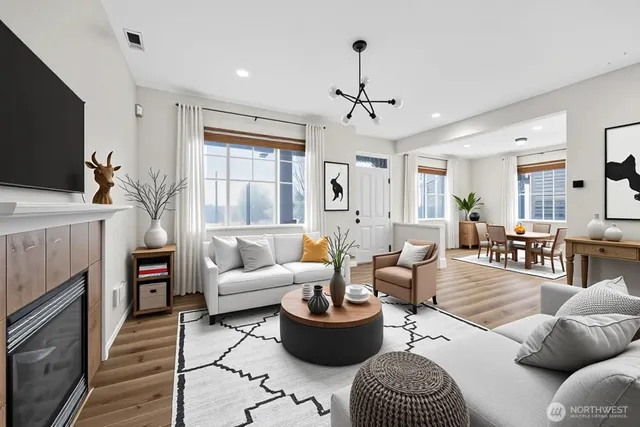 a living room with furniture a fireplace and a flat screen tv