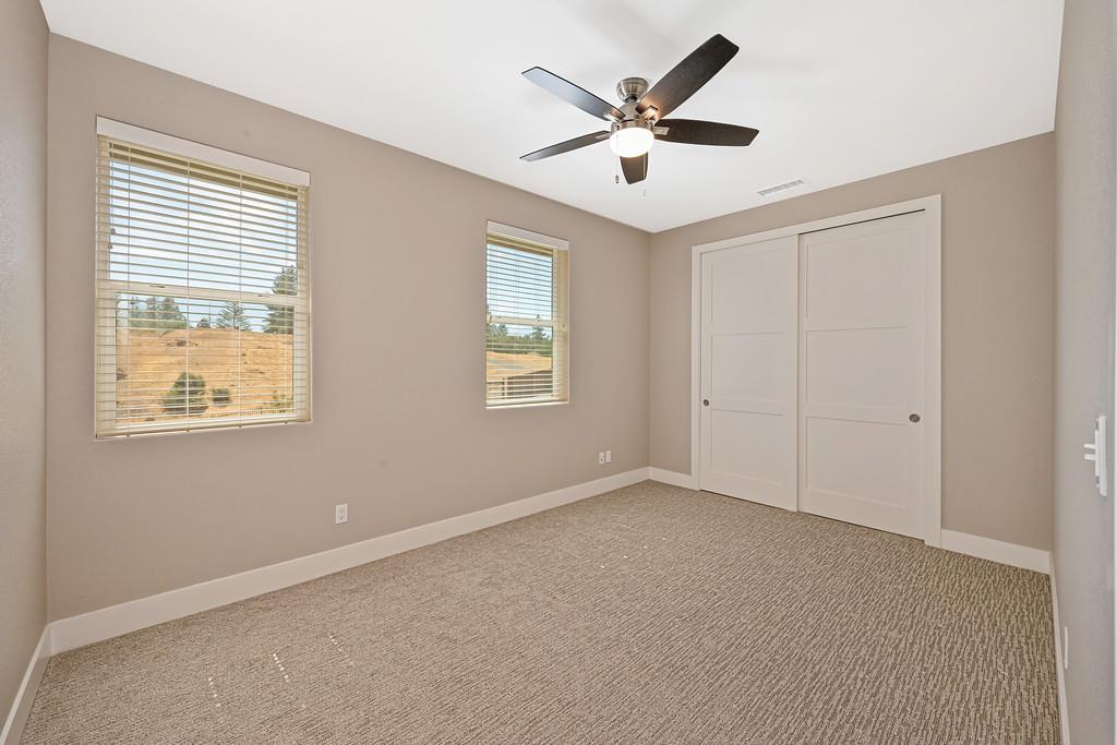504 Chase Court Colfax, CA 95713 - Photo 64 of 94 an empty room with windows and fan