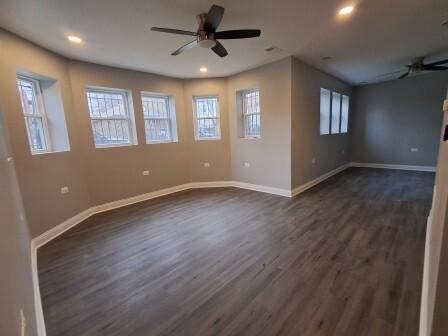 935 West Marquette Road, Unit 9453 Chicago, IL 60621 - Photo 17 of 25 a view of an empty room with a window and wooden floor
