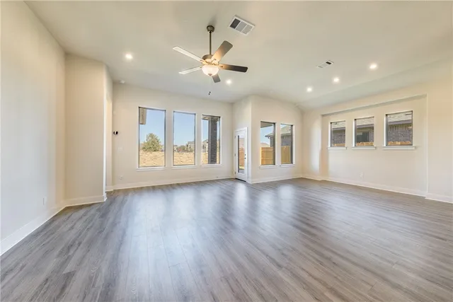 a view of kitchen with kitchen island and stainless steel appliances