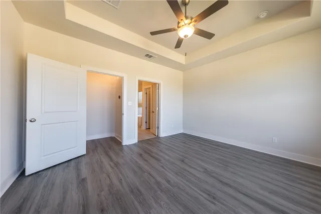 a spacious bathroom with a double vanity sink a mirror a toilet and a bathtub
