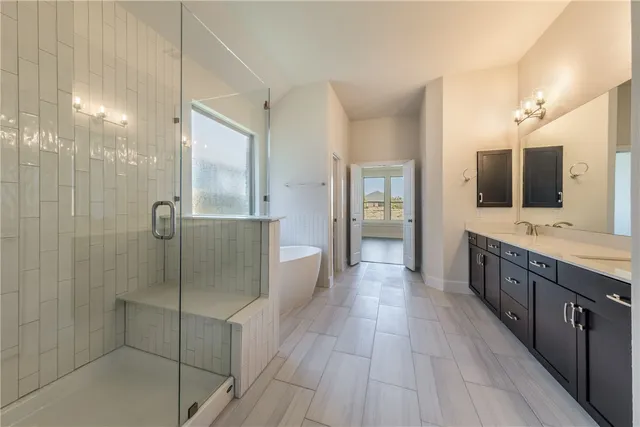 a spacious bathroom with a granite countertop sink mirror and a