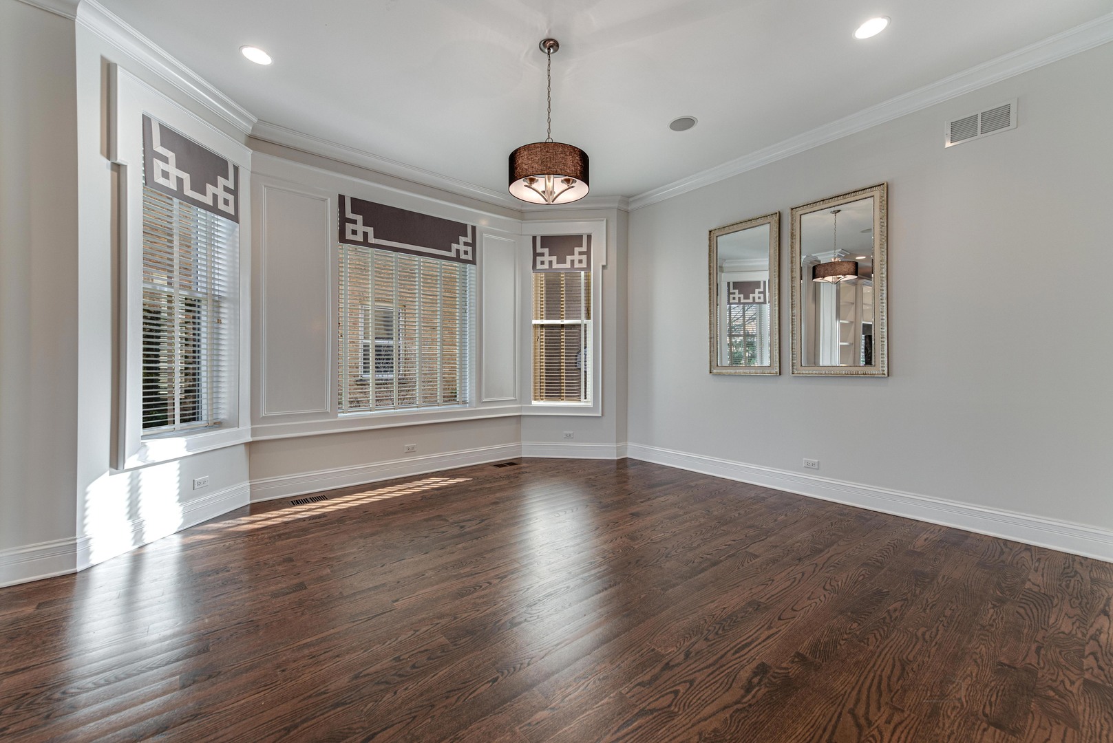 3051 West Logan Boulevard Chicago, IL 60647 - Photo 12 of 52 a view of an empty room with wooden floor and a window