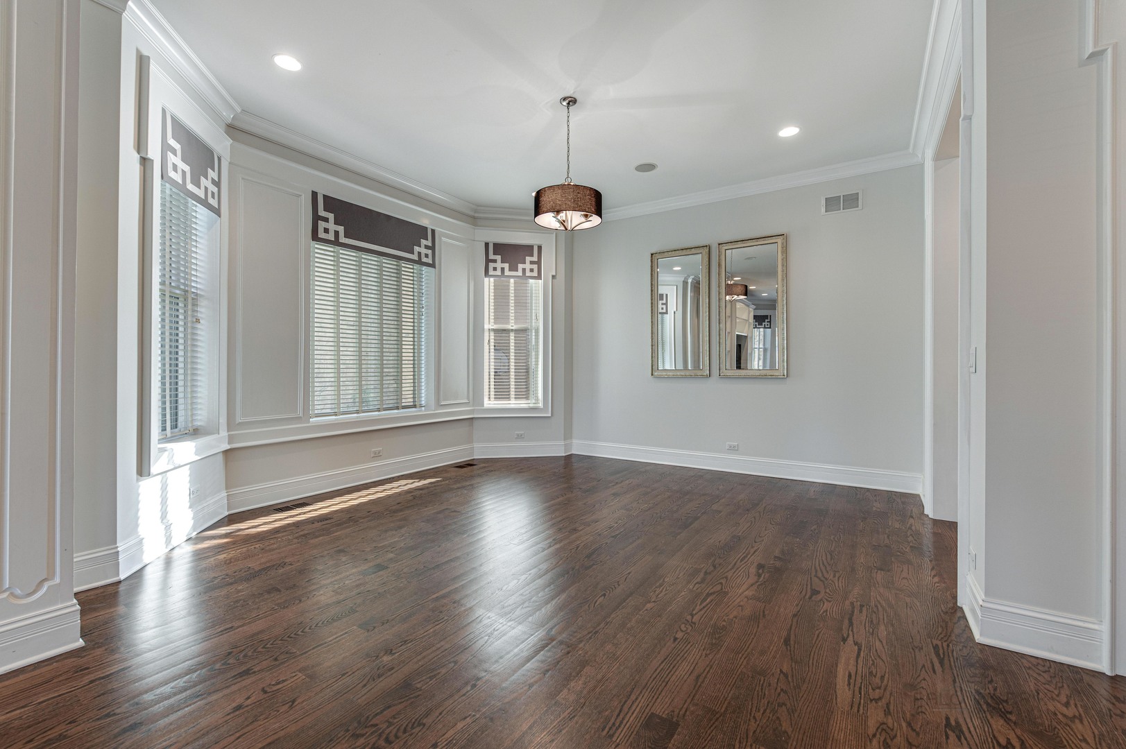 3051 West Logan Boulevard Chicago, IL 60647 - Photo 13 of 52 an empty room with wooden floor windows and cabinet