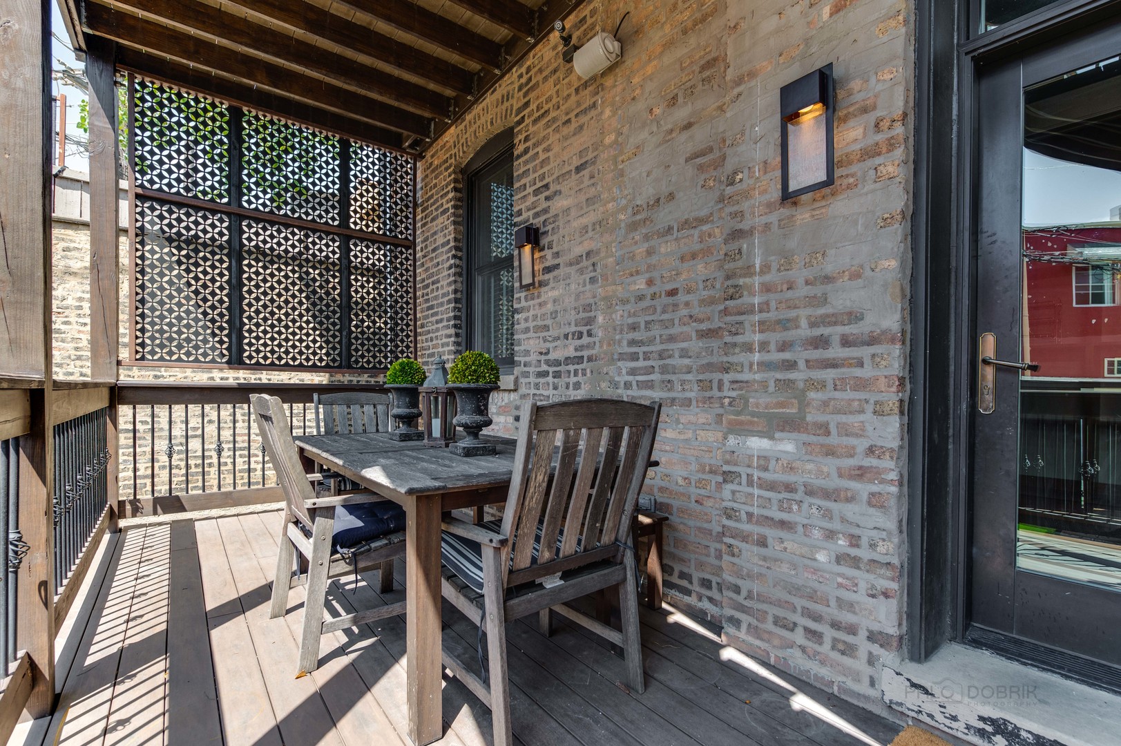 3051 West Logan Boulevard Chicago, IL 60647 - Photo 21 of 52 a view of a patio with table and chairs with wooden floor and fence