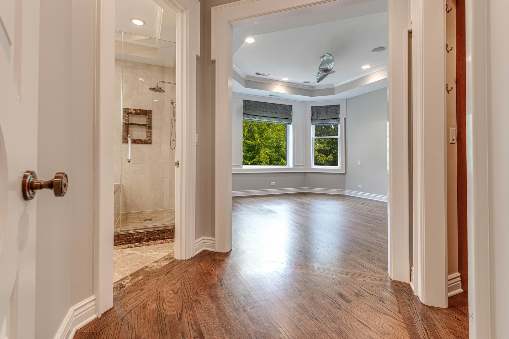 3051 West Logan Boulevard Chicago, IL 60647 - Photo 22 of 52 a view of a hallway with wooden floor and a bathroom