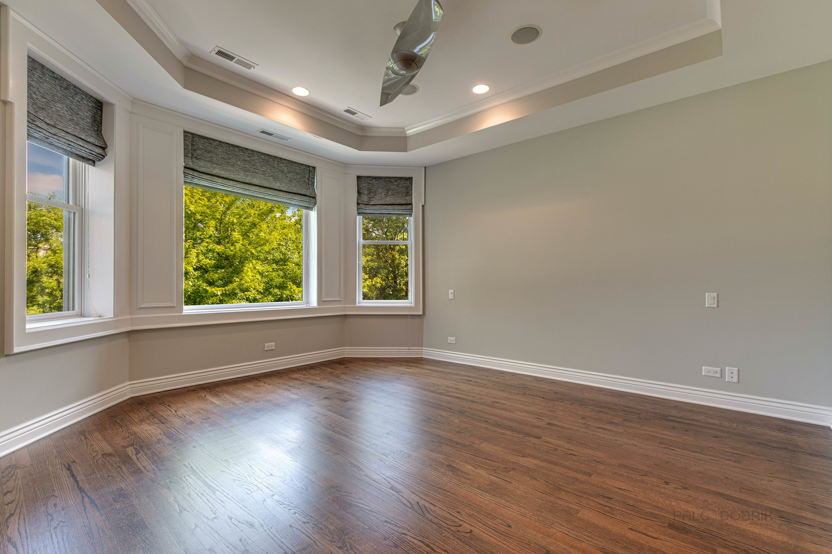 3051 West Logan Boulevard Chicago, IL 60647 - Photo 23 of 52 an empty room with wooden floor and windows