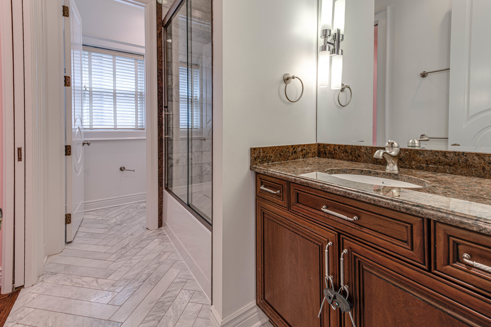 3051 West Logan Boulevard Chicago, IL 60647 - Photo 28 of 52 a bathroom with a granite countertop sink and a mirror
