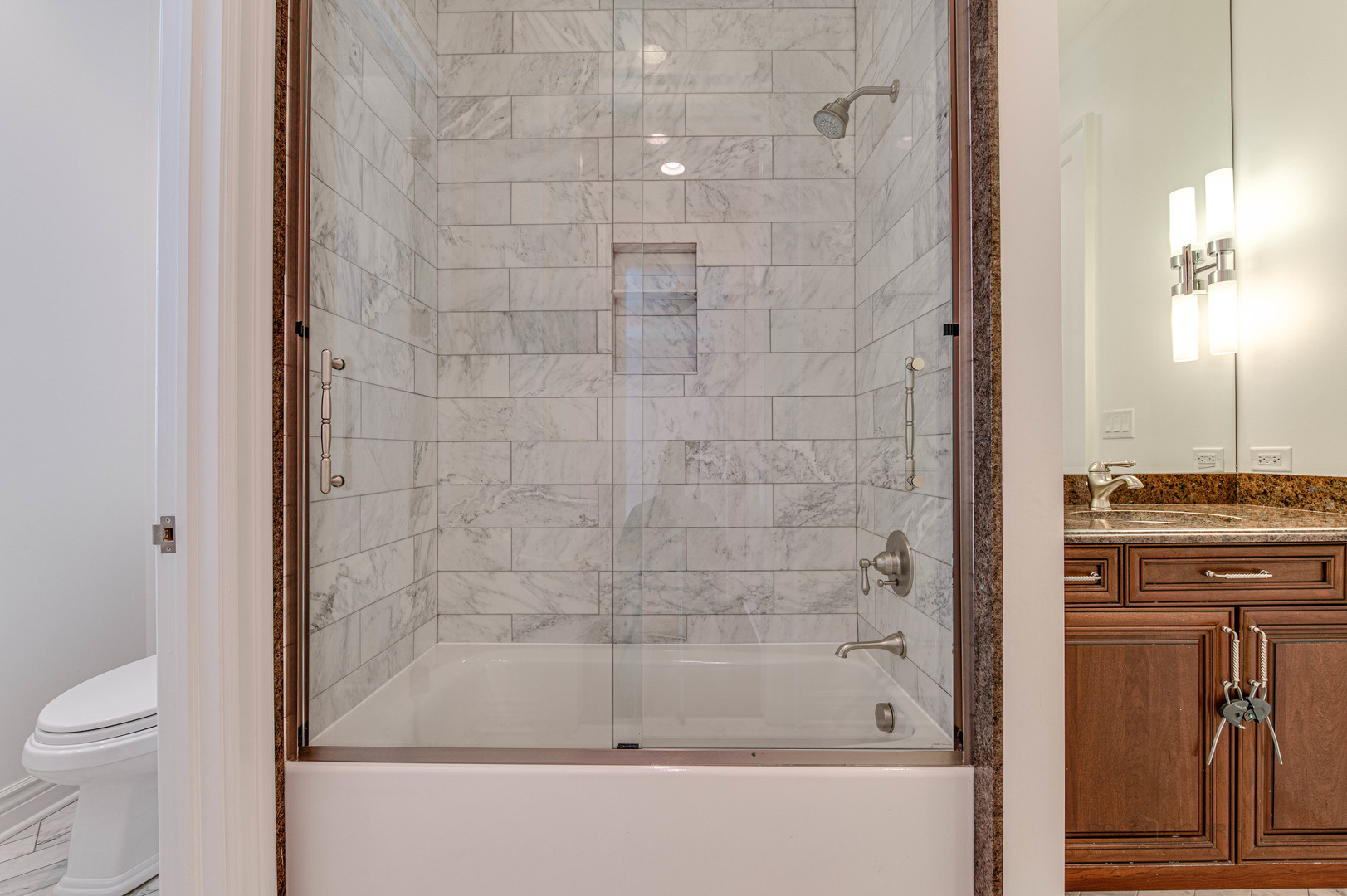3051 West Logan Boulevard Chicago, IL 60647 - Photo 29 of 52 a bathroom with a granite countertop bathtub shower sink vanity and toilet